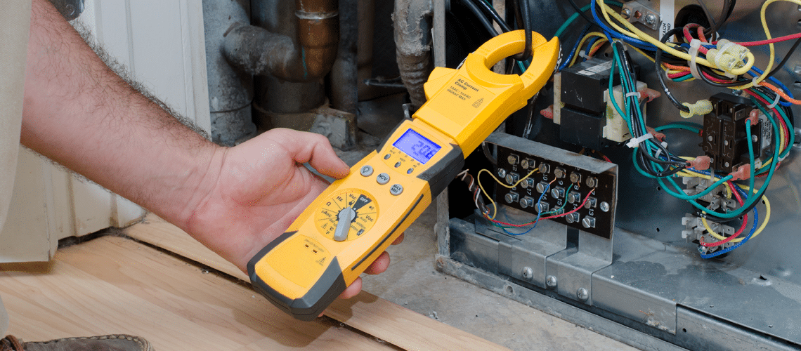a man holding a device for an Air conditioner repair