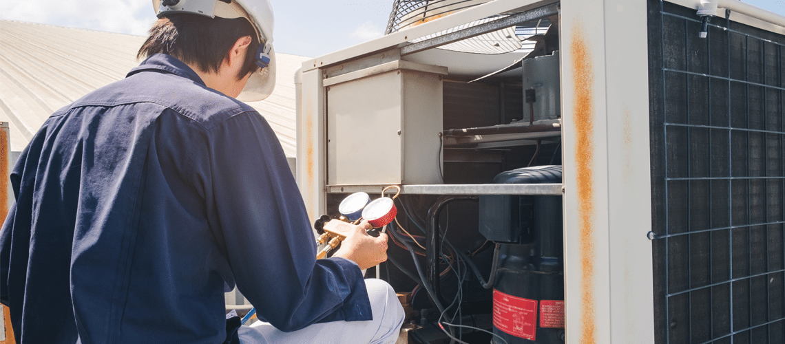 commercial hvac company technician working on an aircondition