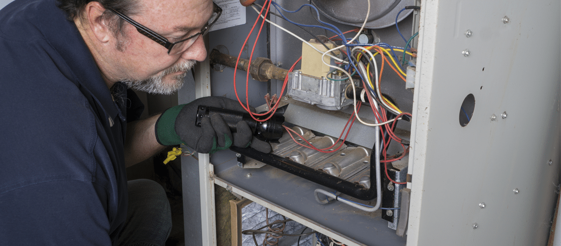 technician making a furnace repair